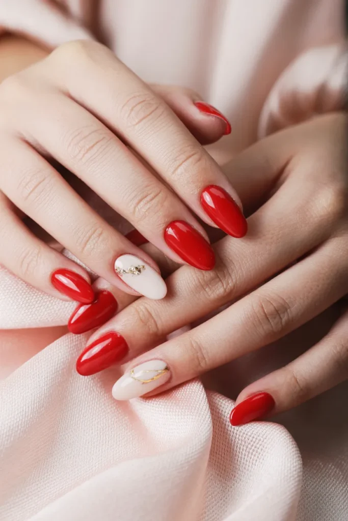 Almond-Shaped Red Nails with Delicate Accents